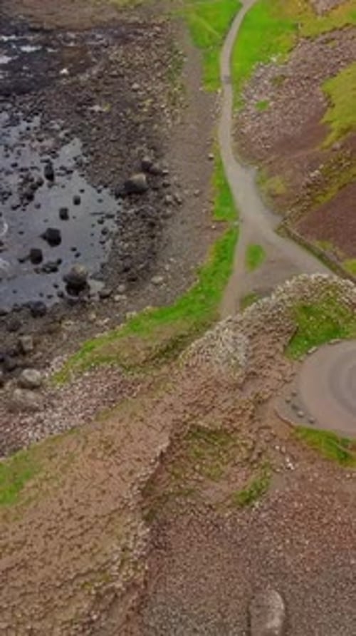 Reversing overhead social ratio aerial video of The Giant's Causeway in Bushmills, Northern Ireland