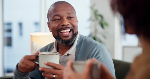 Smiling Man Enjoying Coffee with Friend Indoors