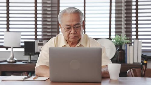 Senior Man Working on Laptop at Home