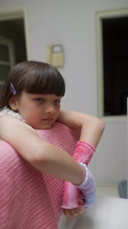 A Thoughtful Girl Wearing Pink Gloves is Sitting in a Cozy and Inviting Setting Reflecting