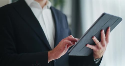Adult Using Tablet Device in Business Attire