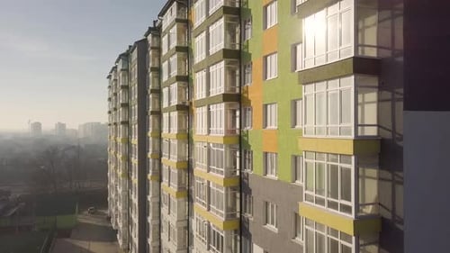 Aerial Footage of a Tall Residential Apartment Building with Many Windows and Balconies