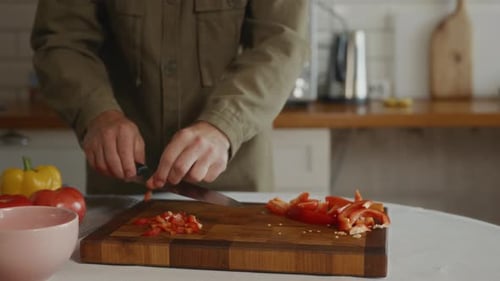 Man Prepares Delicious Meal by Chopping Vegetables
