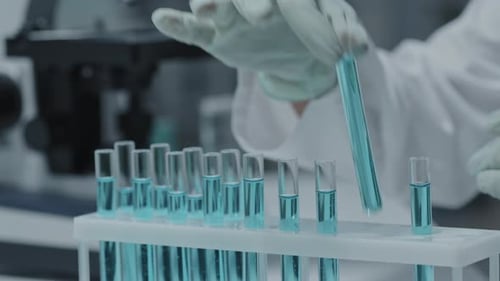 Laboratory Technician Selecting a Test Tube Sample
