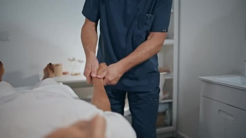 Adult Receiving Hand Exam in Hospital Room