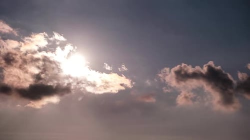 Timelapse of Dramatic Sunset with Sun Rays in the Sky Through Orange Clouds