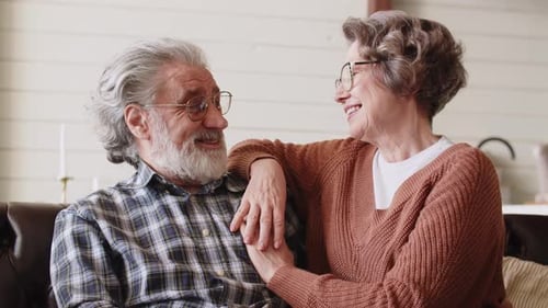 Happy Senior Couple Holding Hands at Home