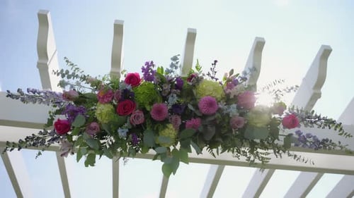 Element of White Wedding Arch with Flowers in Park Romantic Ceremony Setup Move Camera View
