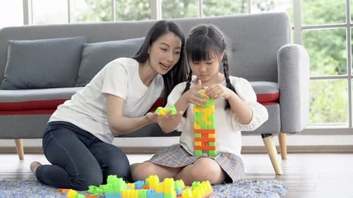 Mother and Child Play with Colorful Building Blocks