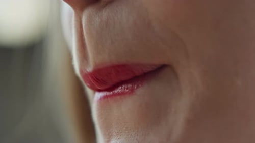 Woman's Lips With Shiny Red Lipstick Close Up