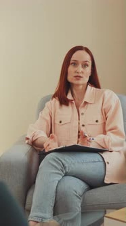 Friendly Woman Speaking with Pen and Clipboard