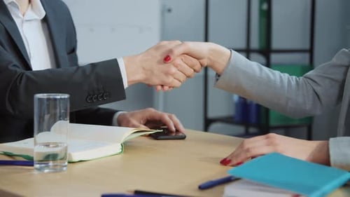 Business Handshake at Desk in Office