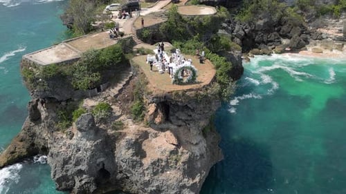 Aerial View of Wedding Ceremony on Scenic Cliff By the Ocean in Bali Indonesia