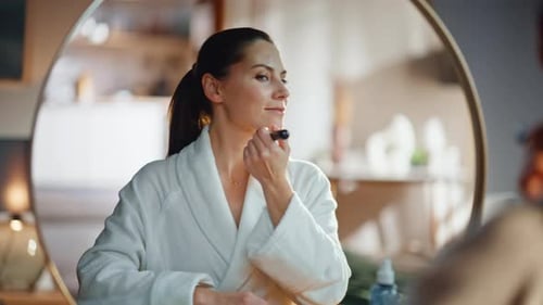 Smiling Woman Applying Powder on Healthy Smooth Face Admiring Reflection Closeup