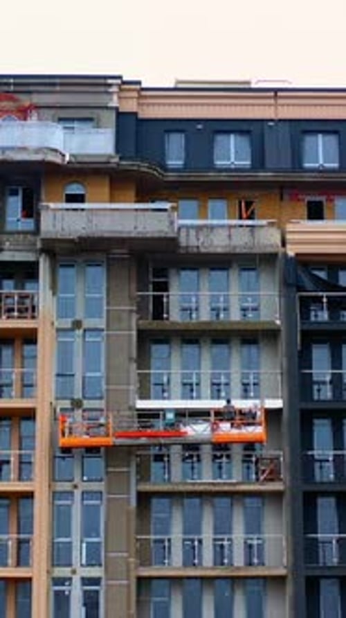 Building of a modern block of flats. Construction of a tower building in the city.