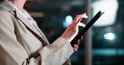 Woman Using Tablet at Night
