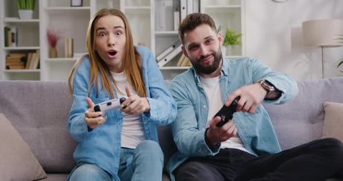 Excited Couple Playing Video Games at Home