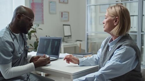 Doctor Consults with Patient in Office