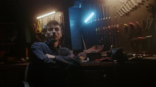 Workshop owner confident man sitting on chair, fold one's arms and looking at camera