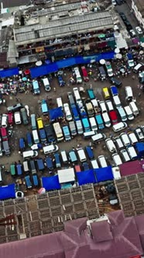 Aerial view of bustling market and vehicle parking in Accra Ghana