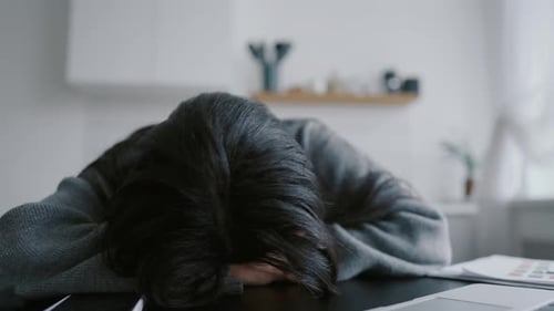 Tired Woman Resting at Desk with Laptop