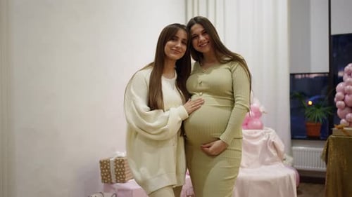 Pregnant Woman Posing with Friend at Baby Shower