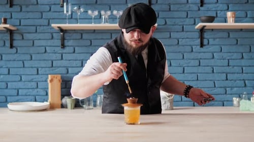 Bartender Lights Unique Cocktail With Blow Torch