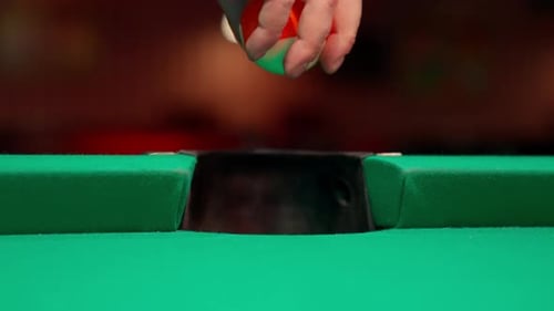Hand Places Billiards Ball by Side Pocket
