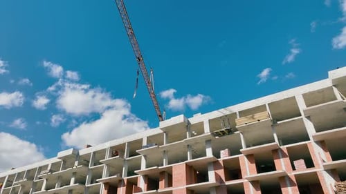 The Construction Crane Moves the Boom Without a Load Construction of a Highrise Building From a