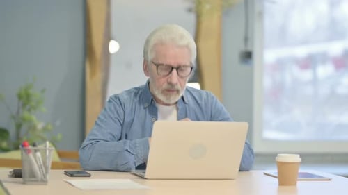 Senior Man on Video Call at Desk