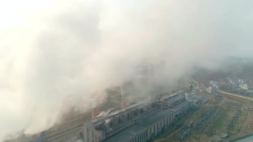 Aerial Drone View of Tall Chimney Pipes with Grey Smoke From Coal Power Plant Production of