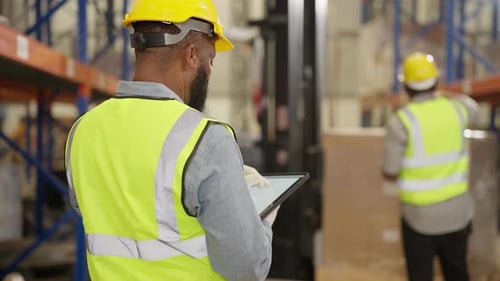 Warehouse worker controlling boxes in warehouse