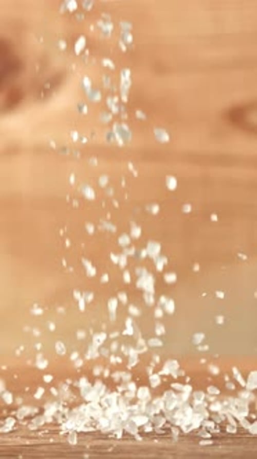Salt Falls on a Wooden Table Filmed on a Highspeed Camera at 1000 Fps