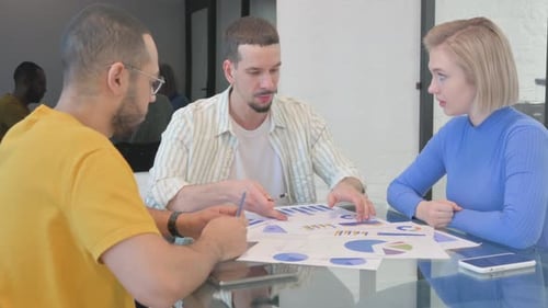 Team Collaborates on Business Charts at Modern Workplace