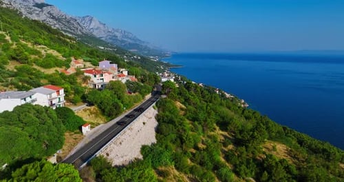 Drone tracking cars on the Makarska riviera coastline in Croatia, summer day