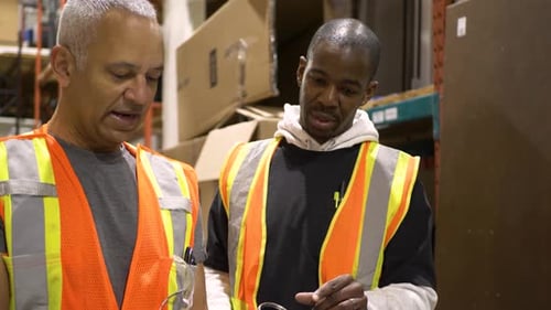 Warehouse Worker and Supervisor Using Digital Tablet and Talking 3539 Years