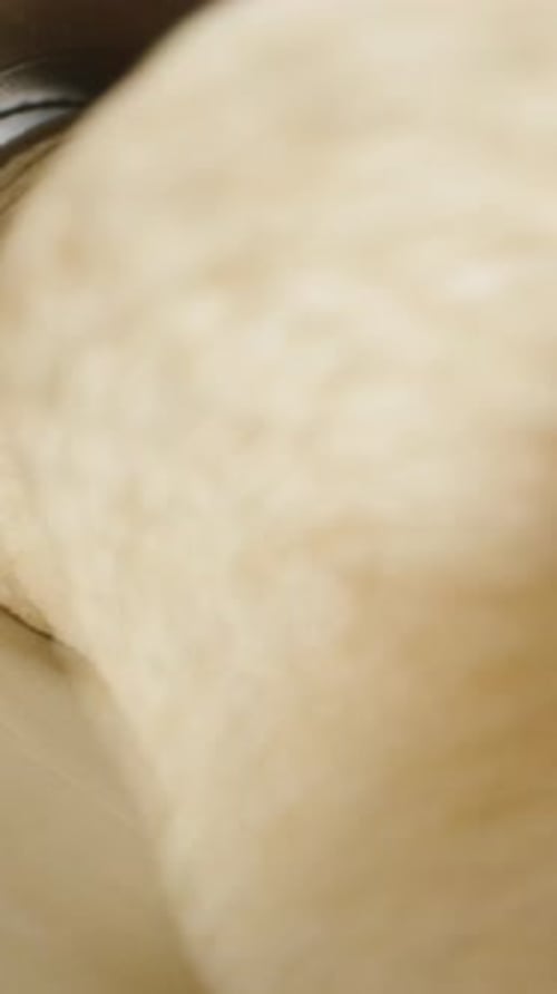 Vertical video. I stack saddle-shaped corn chips into a tall can. Top-down close-up view.