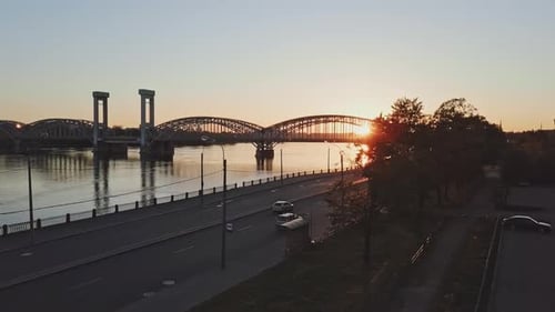 Old metal bridge over a Neva River in Saint-Petersburg with contrast sun and big road