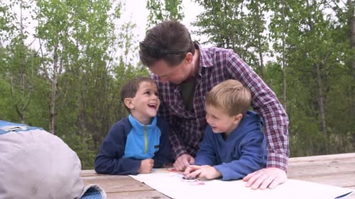 Father and Sons Exploring Nature with Map
