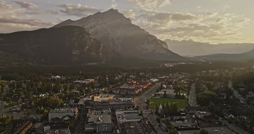 Banff AB Canada Aerial v19 flyover the town capturing forested valley, quaint townscape and Cascade