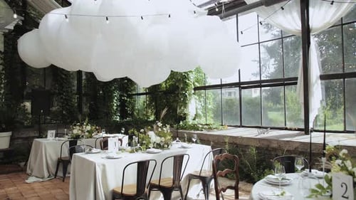 Elegant Event Space with Tables Set for a Wedding