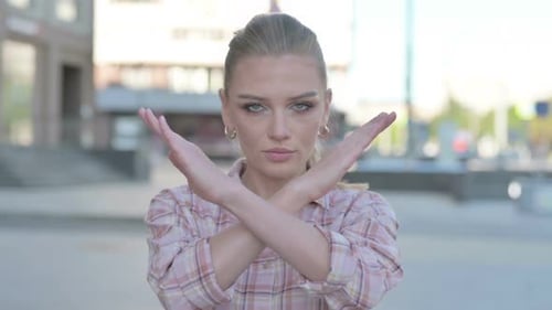 Portrait of Rejecting Young Woman Doing No Gesture Outdoor