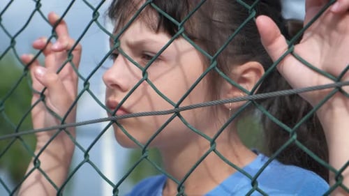 Migrant Behind Prison Net