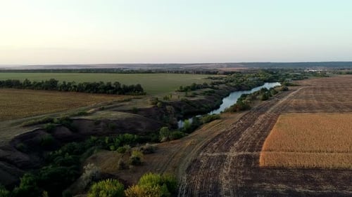 Aerial View of River Framed By Fields