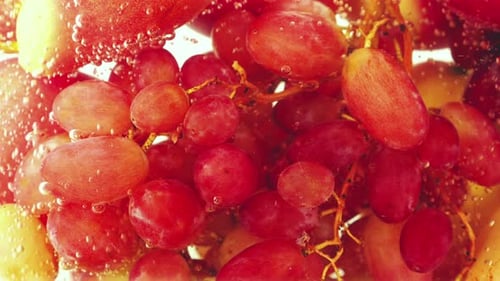 Background with fruits and berries in water with air bubbles.