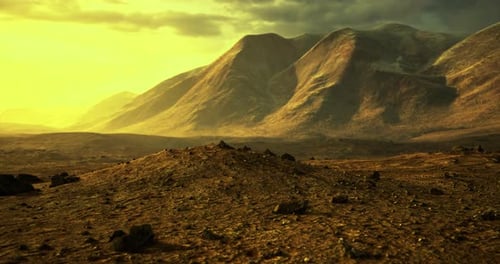 Stunning Golden Landscape with Mountains Under a Dramatic Sky at Sunset