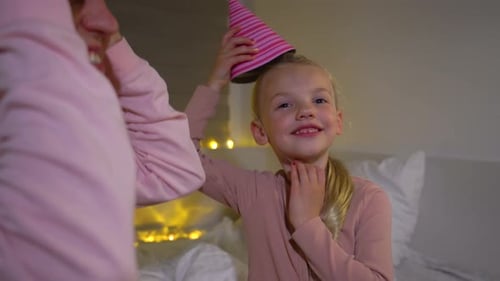 Child and Adult Celebrate Birthday with Party Hat