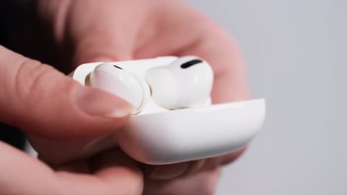 Hands Remove Wireless Earbuds From White Case