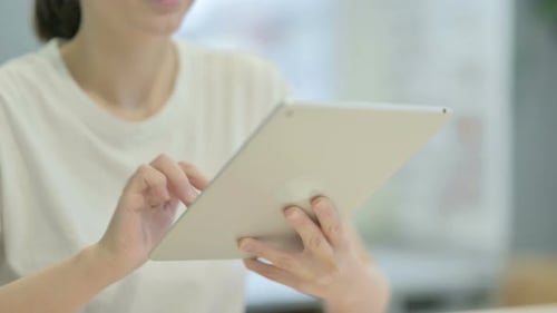 Close up of Casual Young Woman Using Digital Tablet