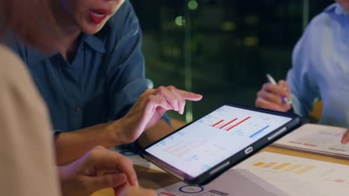 Asia businesspeople meeting plan analysis statistics brainstorm at office night.